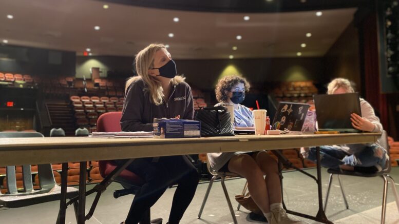 “Cry it Out” director Christine Fogarty observes the action on stage while her stage manager Alicia Perez and assistant stage manager Megan Price keep watch of the scripts to ensure the actors say the correct lines.