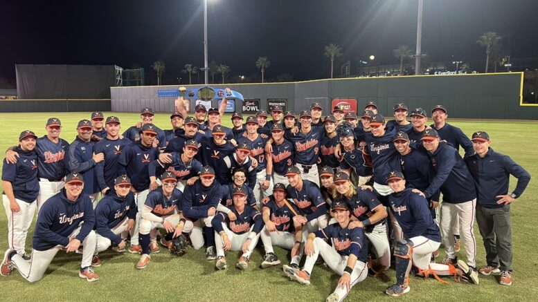 The 'Hoos hoists the championship belt, celebrating winning the Jax College Baseball Classic in right field following Sunday's late game. Photo courtesy of @jaxcbc via twitter.