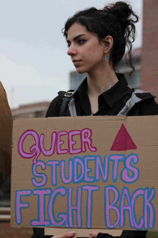 A student protesting outside the FSU Student Union. Photo by Logan Michael.